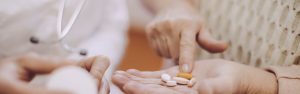 patient-hands-holding-medications-and-discussing-with-doctor