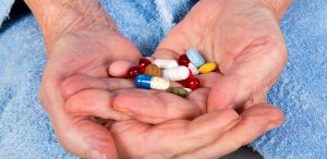 hands-of-an-elderly-woman-holding-lots-of-pills