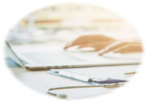 doctor-typing-information-on-laptop-in-hospital-office-focus-on-picture